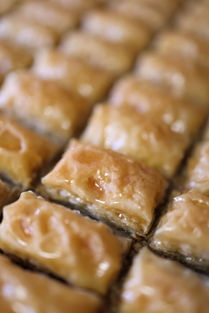 Delicious close-up of golden baklava pastries, perfect for dessert lovers and food photography enthusiasts.